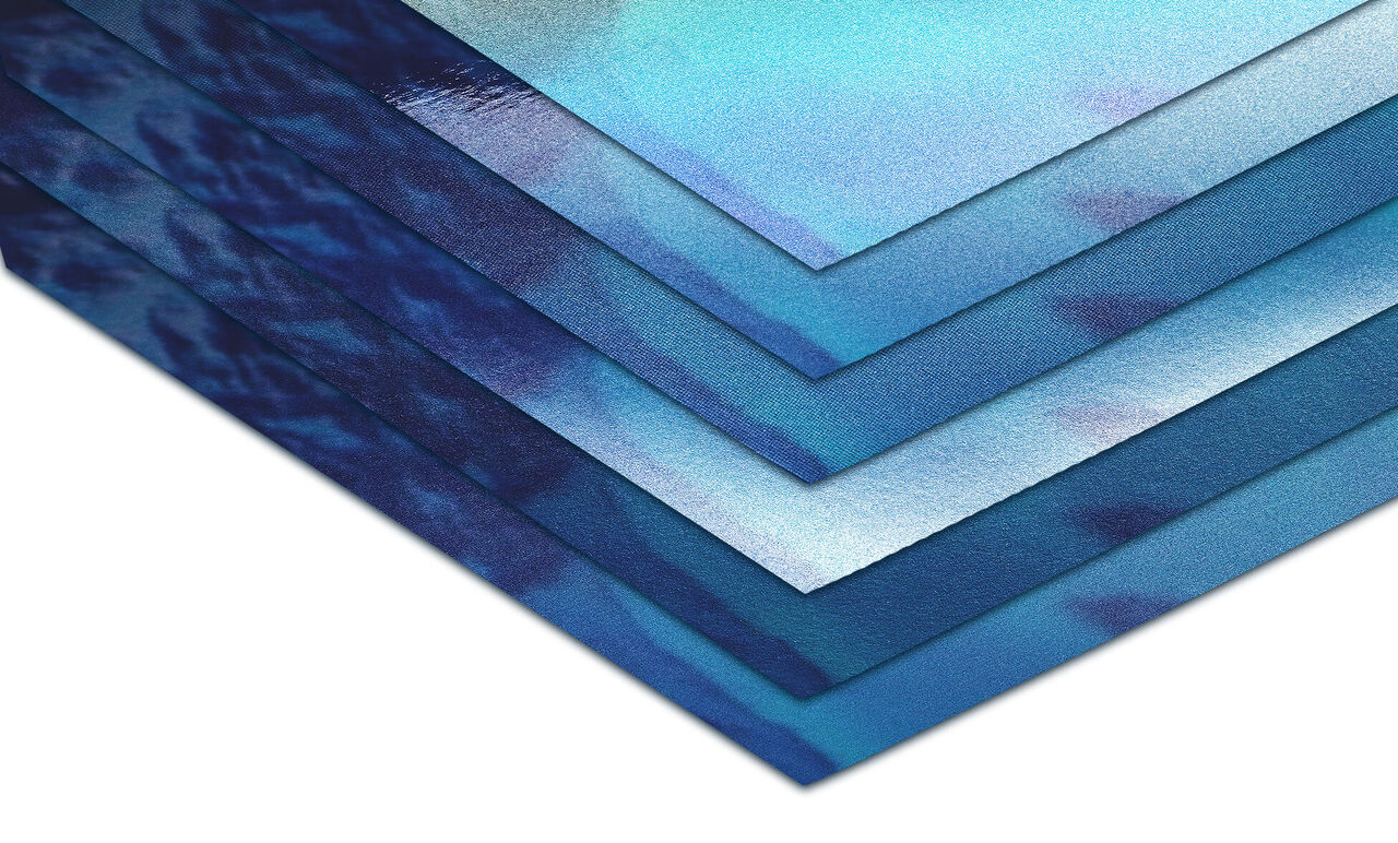 Various blue papers stacked on top of each other, perfect for creative designs.