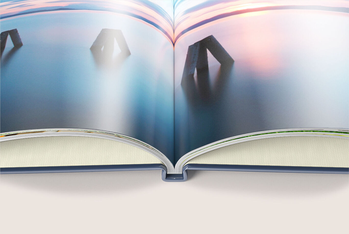 Open CEWE photo book with landscape images and a green sustainability label.