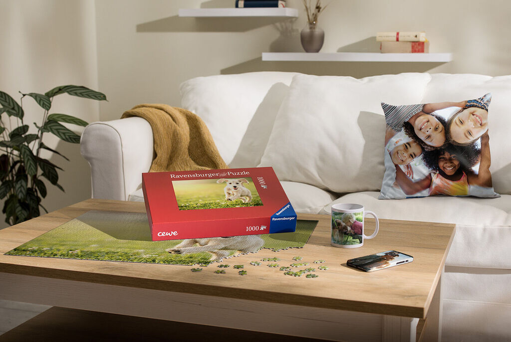 A lovingly arranged table with CEWE puzzle, mug, and cushion showing personal memories.