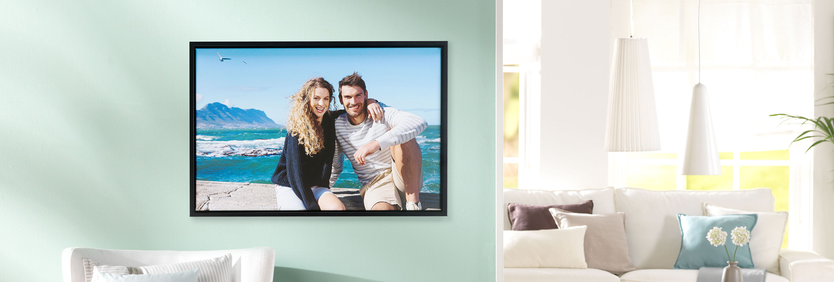 A happy couple sitting at a beautiful spot overlooking the sea.