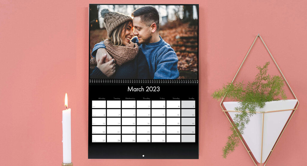 A couple embraces against a beautiful background in March 2023.