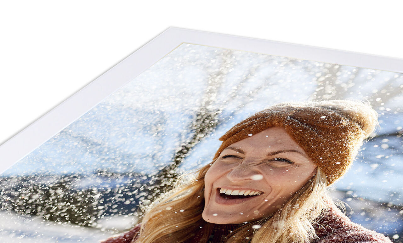 A person in a winter coat with a snow background