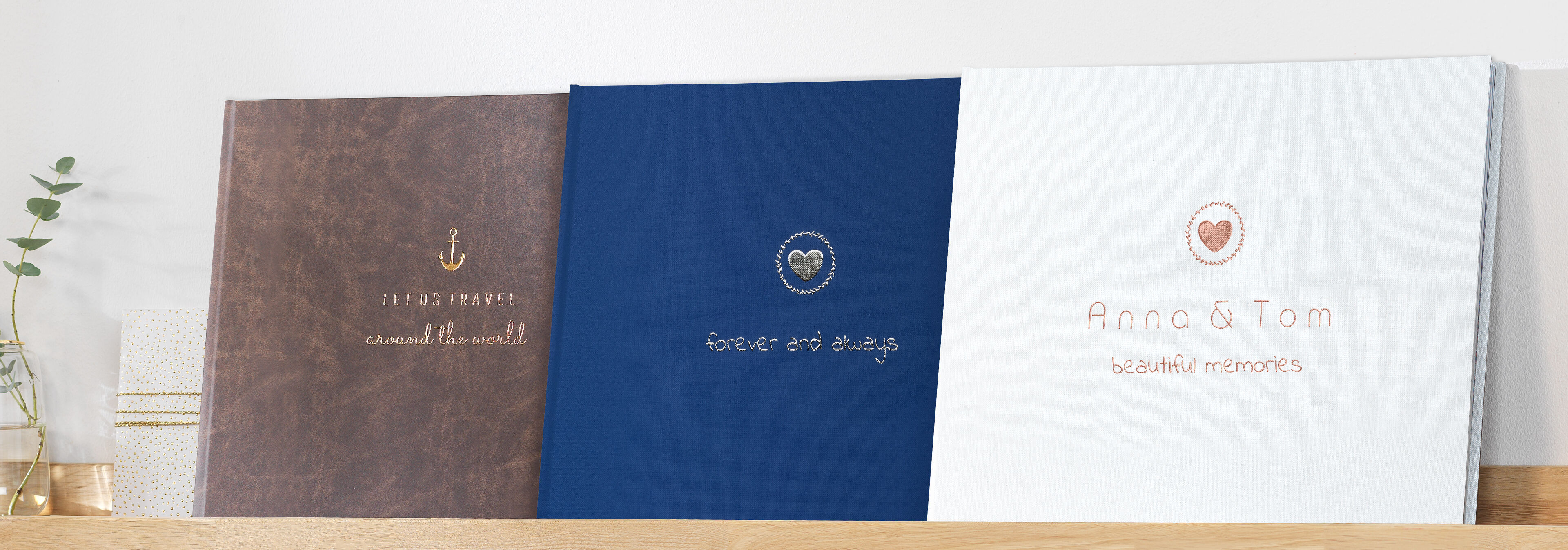 Three creative photo books on a shelf, each with a unique design and title.