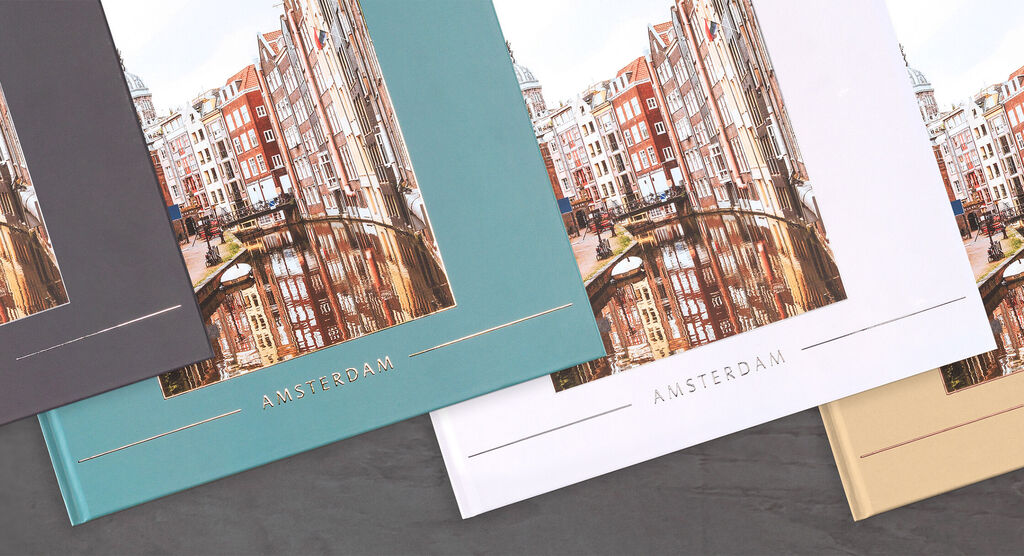 Three variants of a CEWE photo book featuring Amsterdam motifs on the cover.
