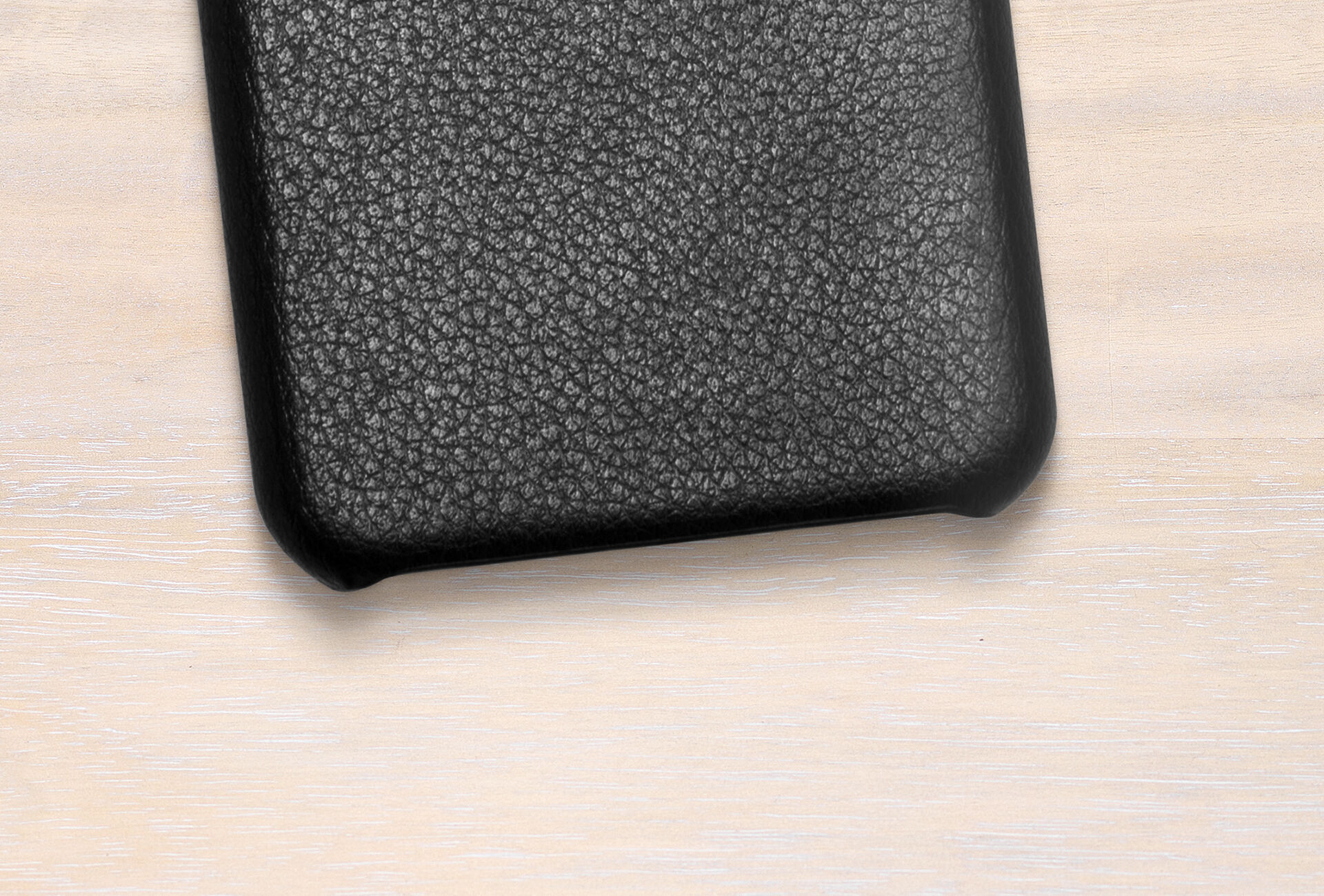 Black phone case with textured design on light background
