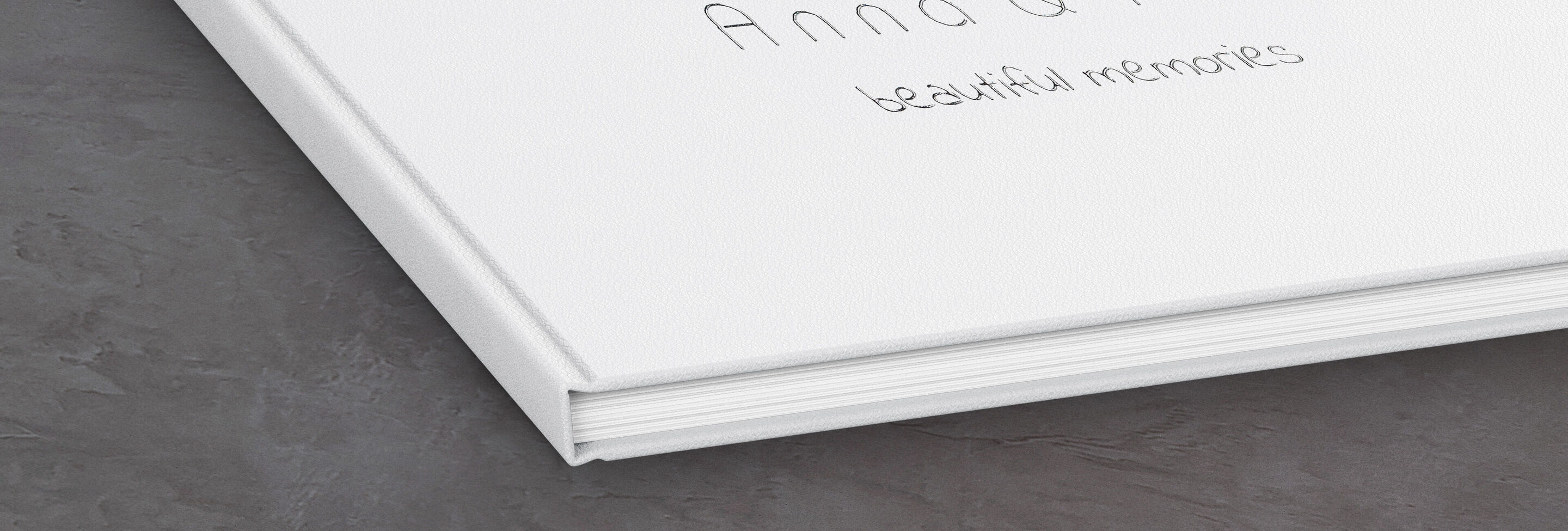 White photo book with handwritten title "Anna and Peter – Beautiful Memories."