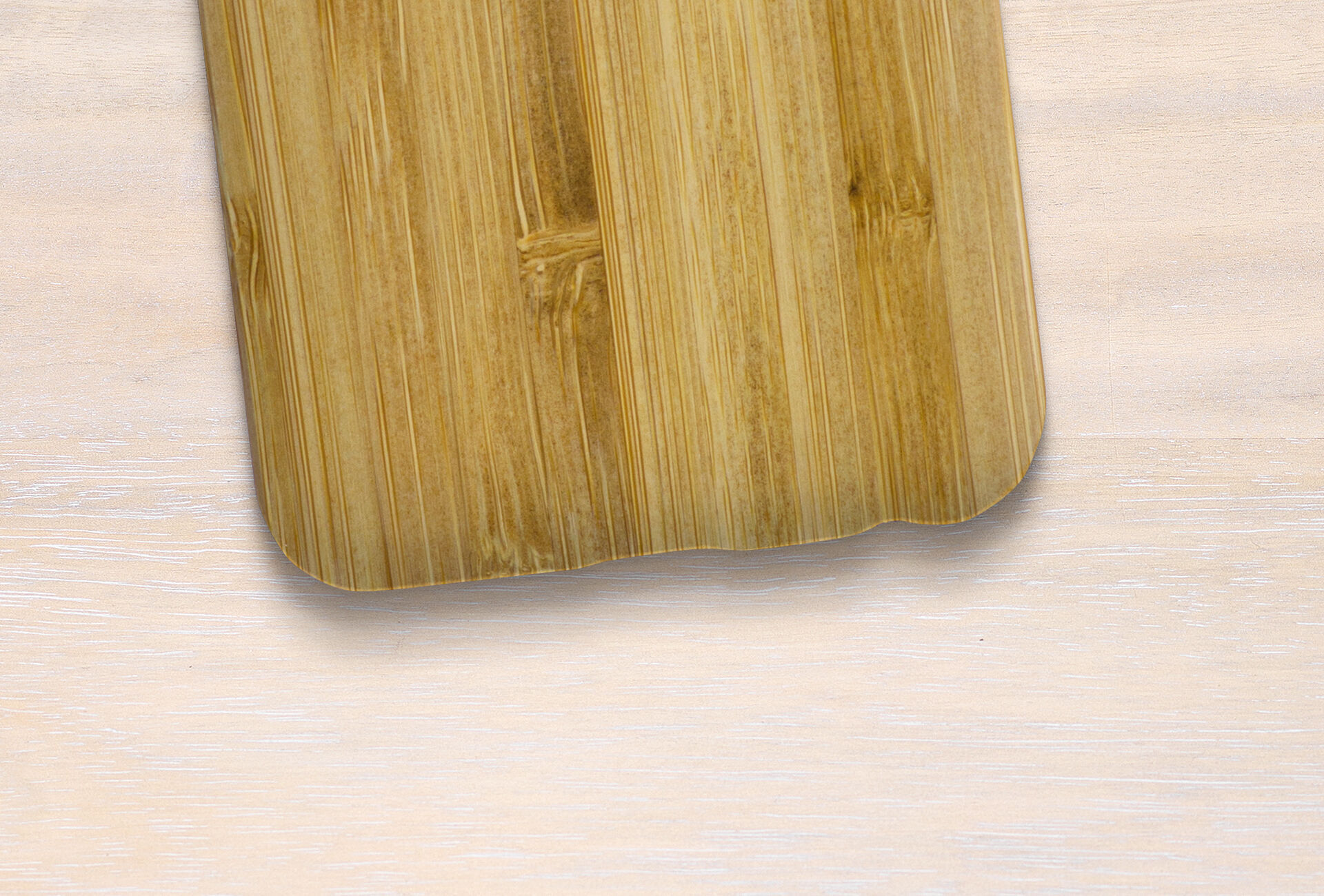Light bamboo cutting board on a wooden surface