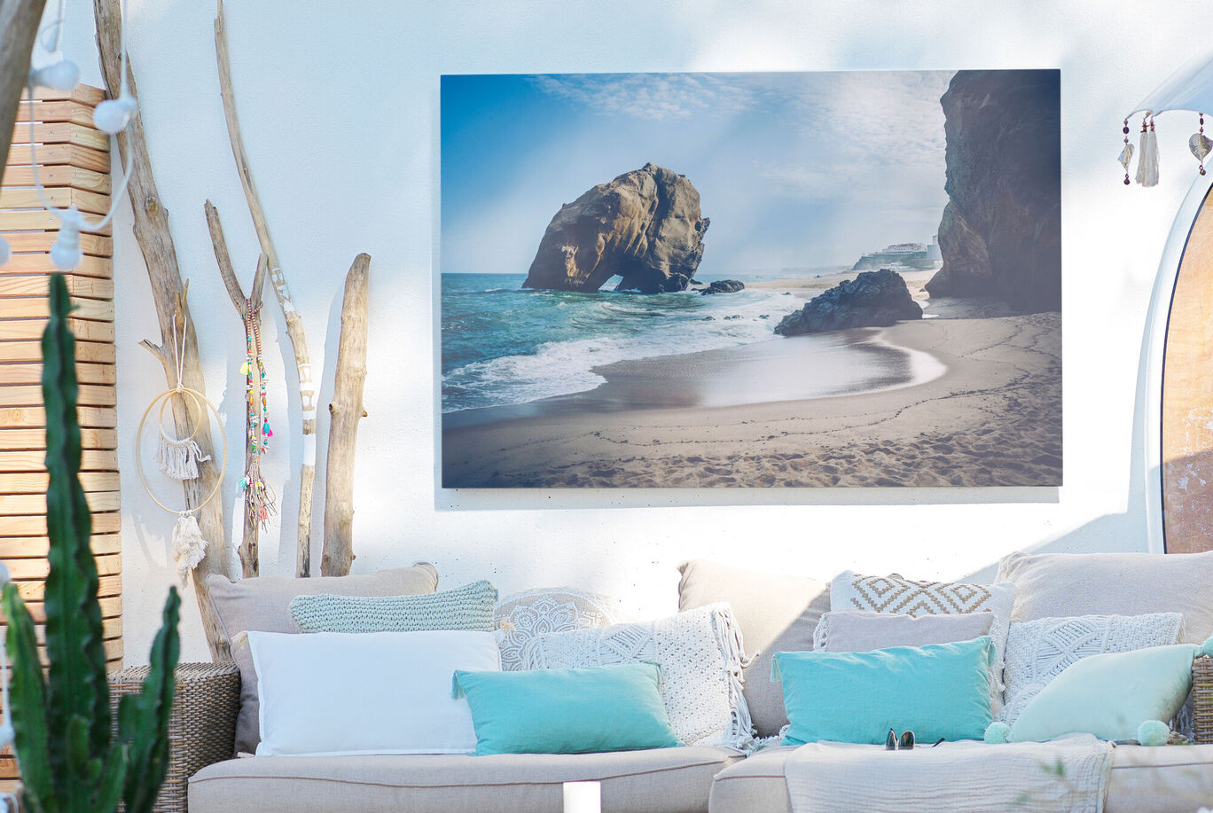 A stunning wall picture of a beach with rocks and gentle waves, conveying a relaxed atmosphere.
