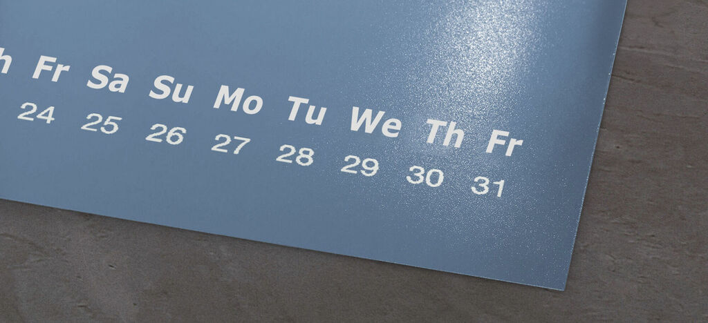 A blue wall calendar with white days and numbers.