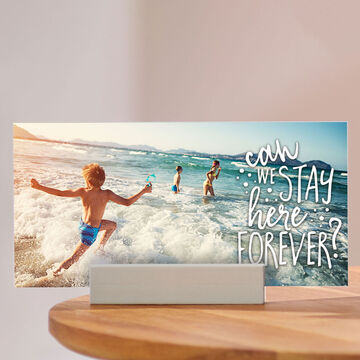 Child happily jumps in the water at the beach, text: 'can we stay here forever?'