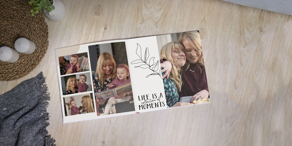 Two women laugh while flipping through a photo book. Beautiful visual memories and a heartwarming atmosphere.