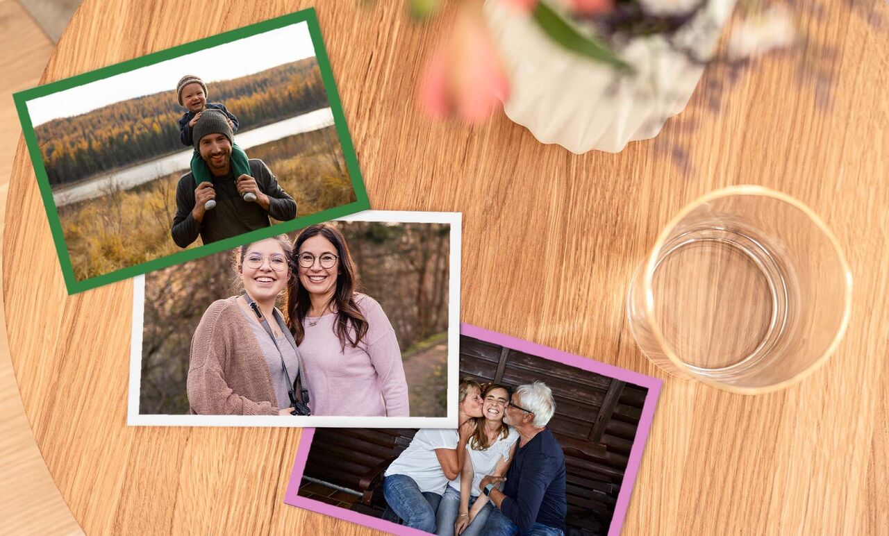 Three photos on a wooden table. Above, a picture of a child on the shoulders of an adult, a lake in the background. In the middle, a photo of two women outdoors, and below an image of a smiling group.