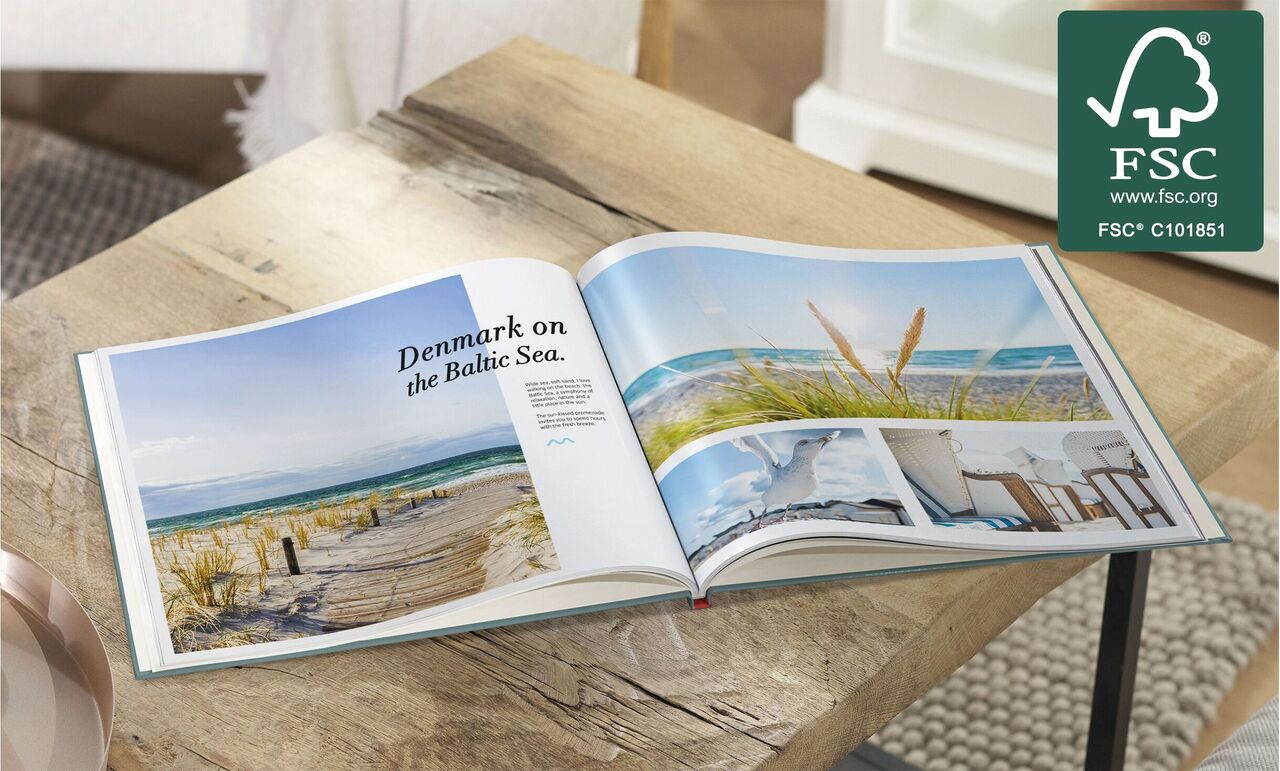 Open photo book shows beautiful beach landscape in Denmark