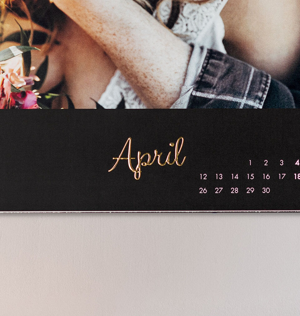 Calendar page for the month of April with golden writing and floral decor