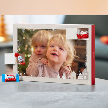A festive arrangement with an empty picture frame and Christmas sweets.