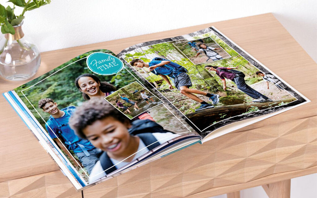 An open photo book with hiking photos. Memories of joyful outings with friends in nature.