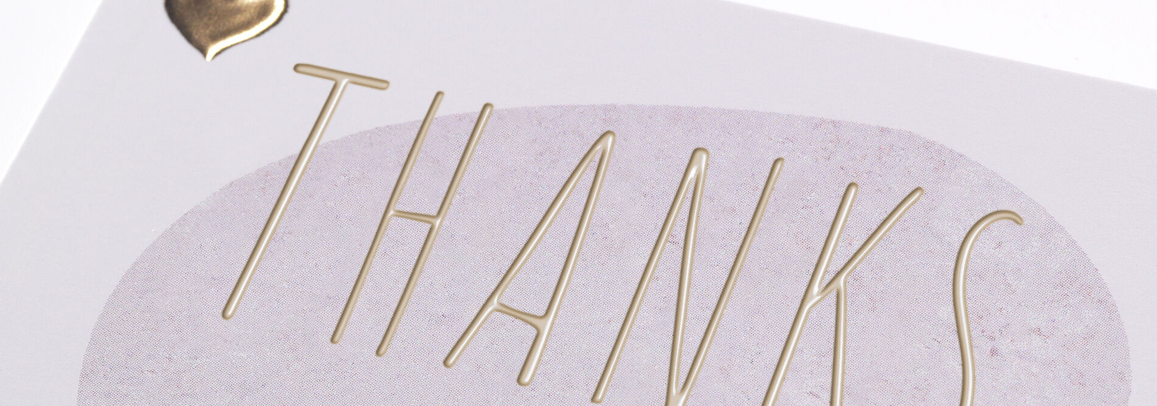 Thank you card with gold lettering 'Thanks' on a pastel-colored background.