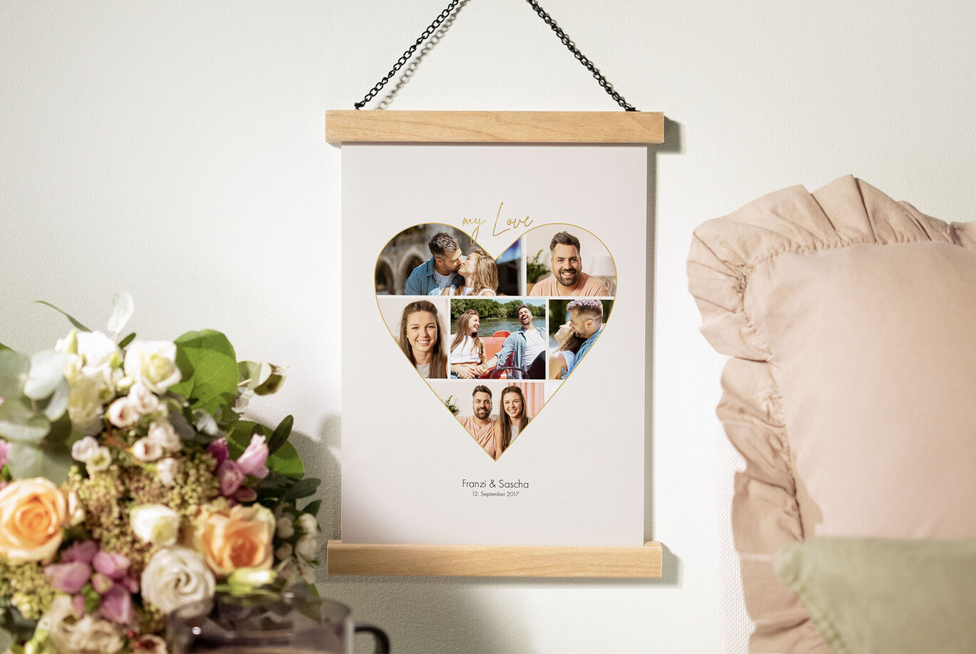 Heart-shaped wall art with photos of happy moments and flowers in the background.