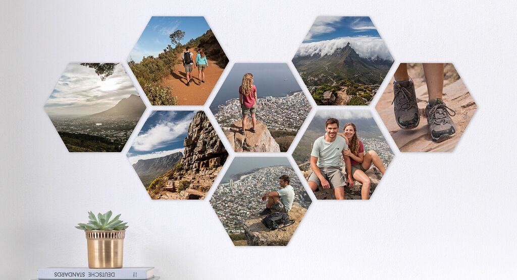Creative wall art with hexagonal photo collage motifs from various travel moments, including landscapes and happy people.