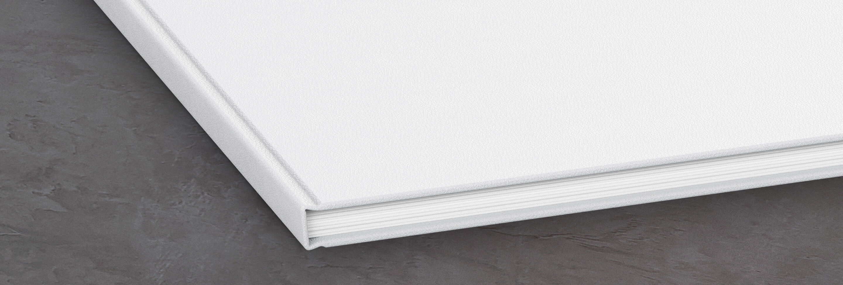 Close-up of an open white CEWE photo book.
