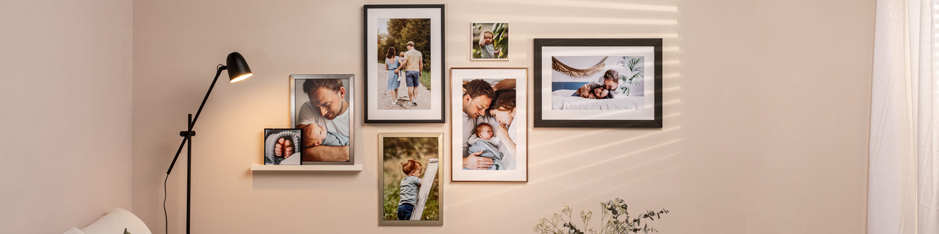 Cozy living room wall with various framed photos showing beautiful family moments.