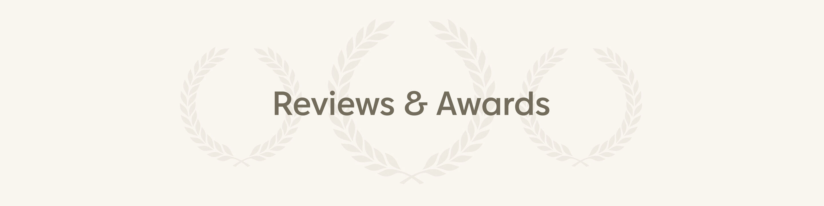 The image shows subtle text in green saying 'Reviews & Awards', framed by elegant golden laurel wreaths.