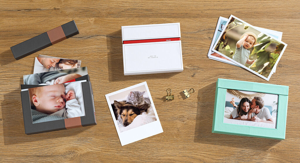 Beautiful photo cards and memorabilia in various designs on a wooden surface.