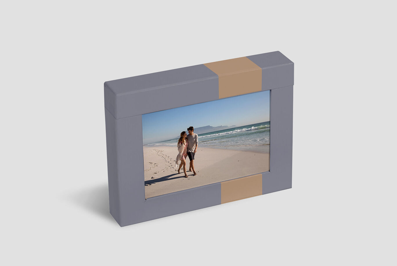 A pretty photo album with a picture of a couple on the beach. The sun is shining, and they enjoy the moment.