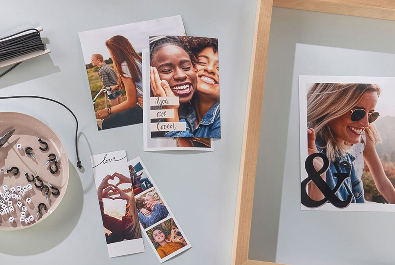 A creative arrangement of photos and craft materials on a table, ideal for memory design.