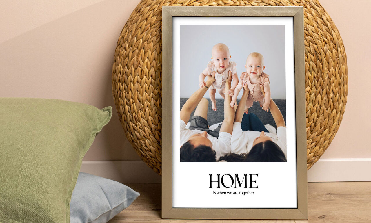 A beautiful family moment at home: A couple holds two babies in their hands and smiles.
