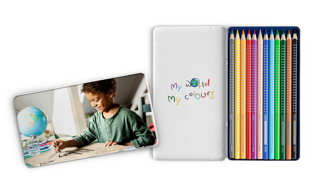 A child draws with colorful pencils. On the right, many colored pencils and a notebook titled 'my world my colours' can be seen.