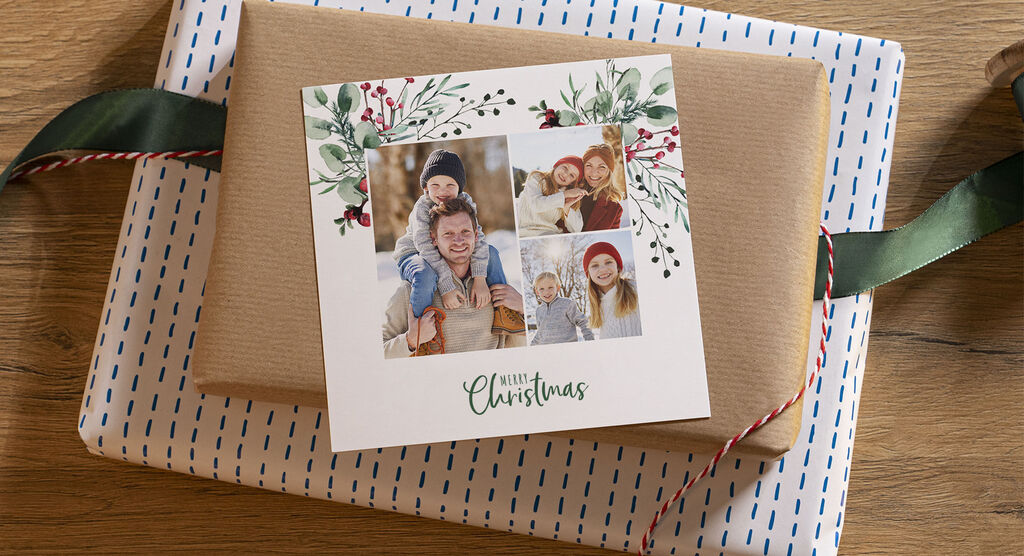 A nicely wrapped gift with a photo of a family and Christmas motifs on the card