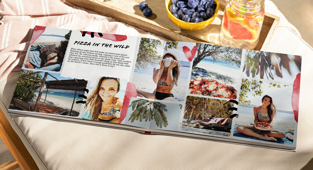An open photo book with great vacation memories, including pictures of pizza in nature and a beach scene.