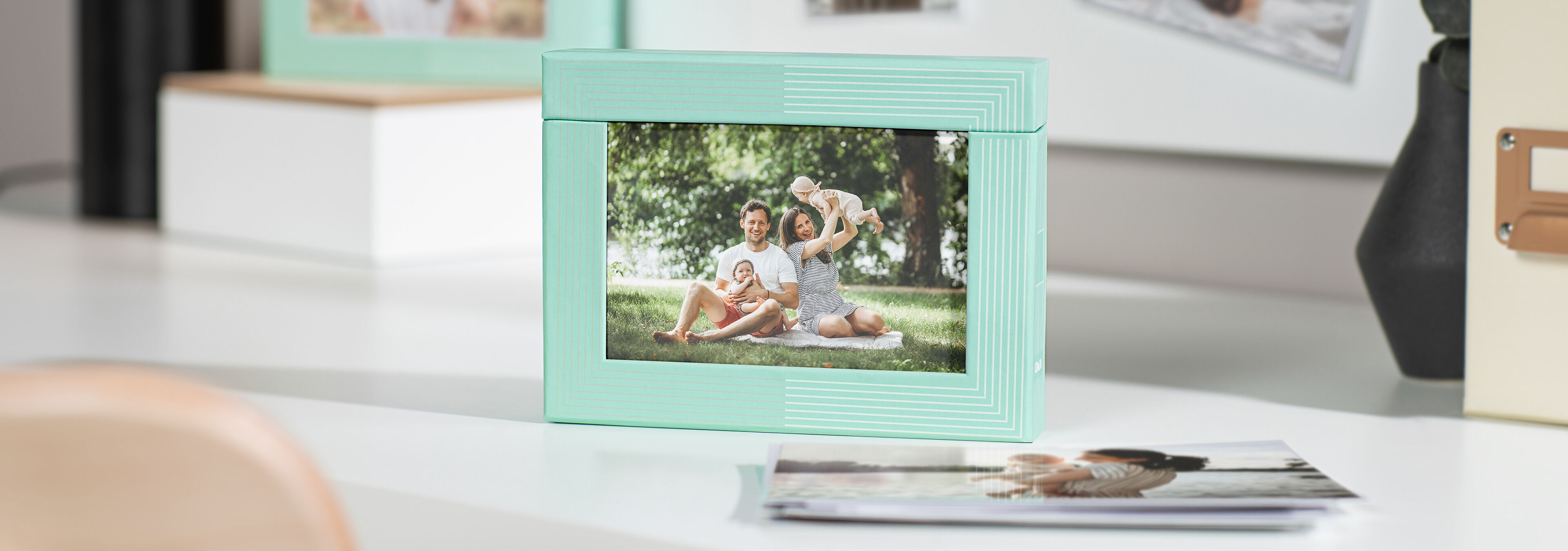 Family enjoys an outdoor trip. A cheerful picture with a mint green frame.