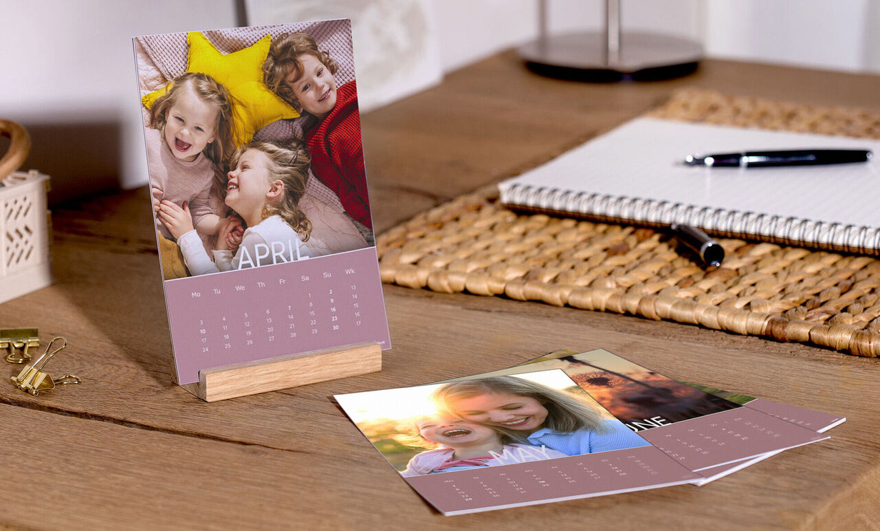 A cheerful desk calendar with pictures of smiling children in a warm room