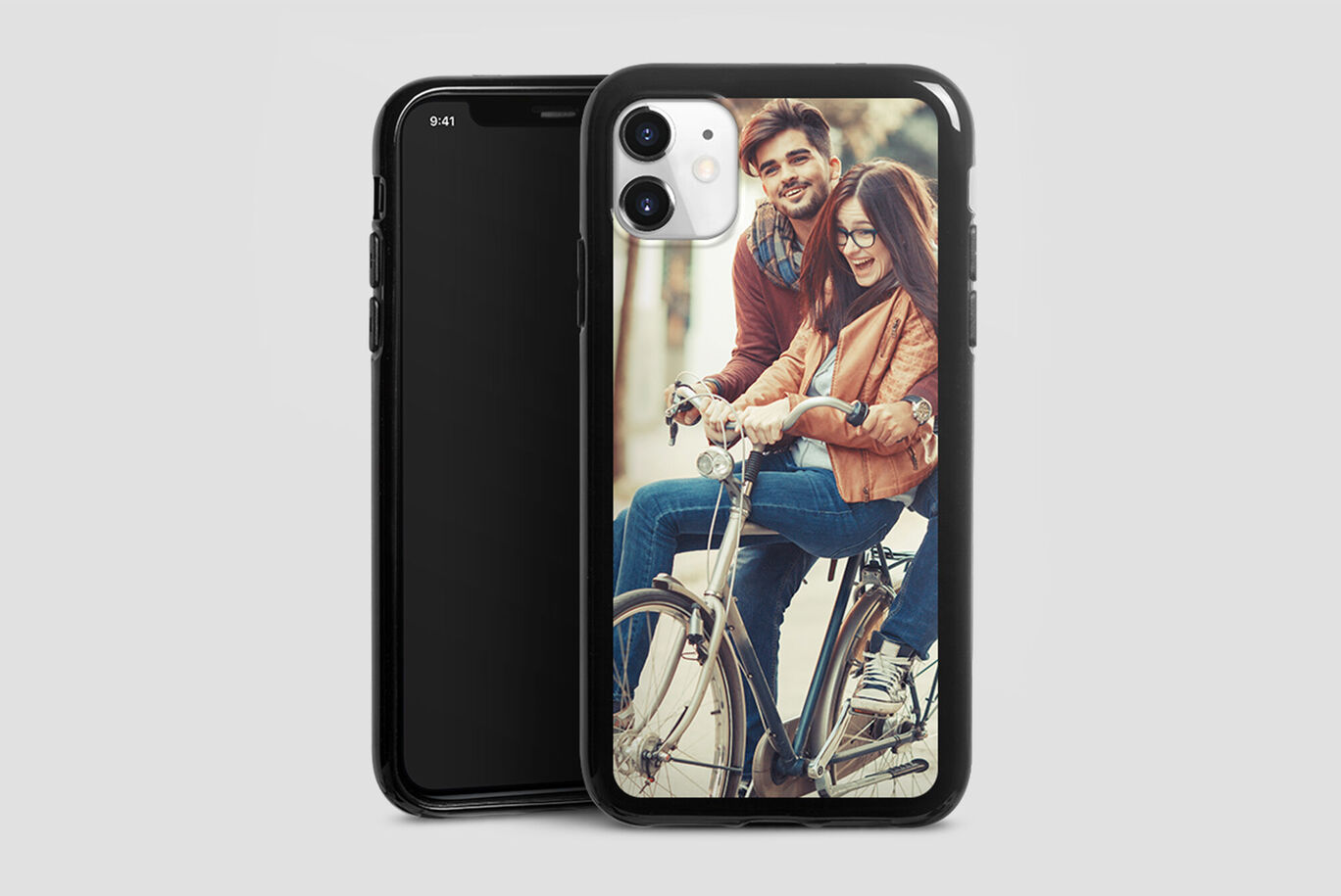 Two people on a bicycle, one holds a smartphone, a cheerful moment. CEWE Photo Book