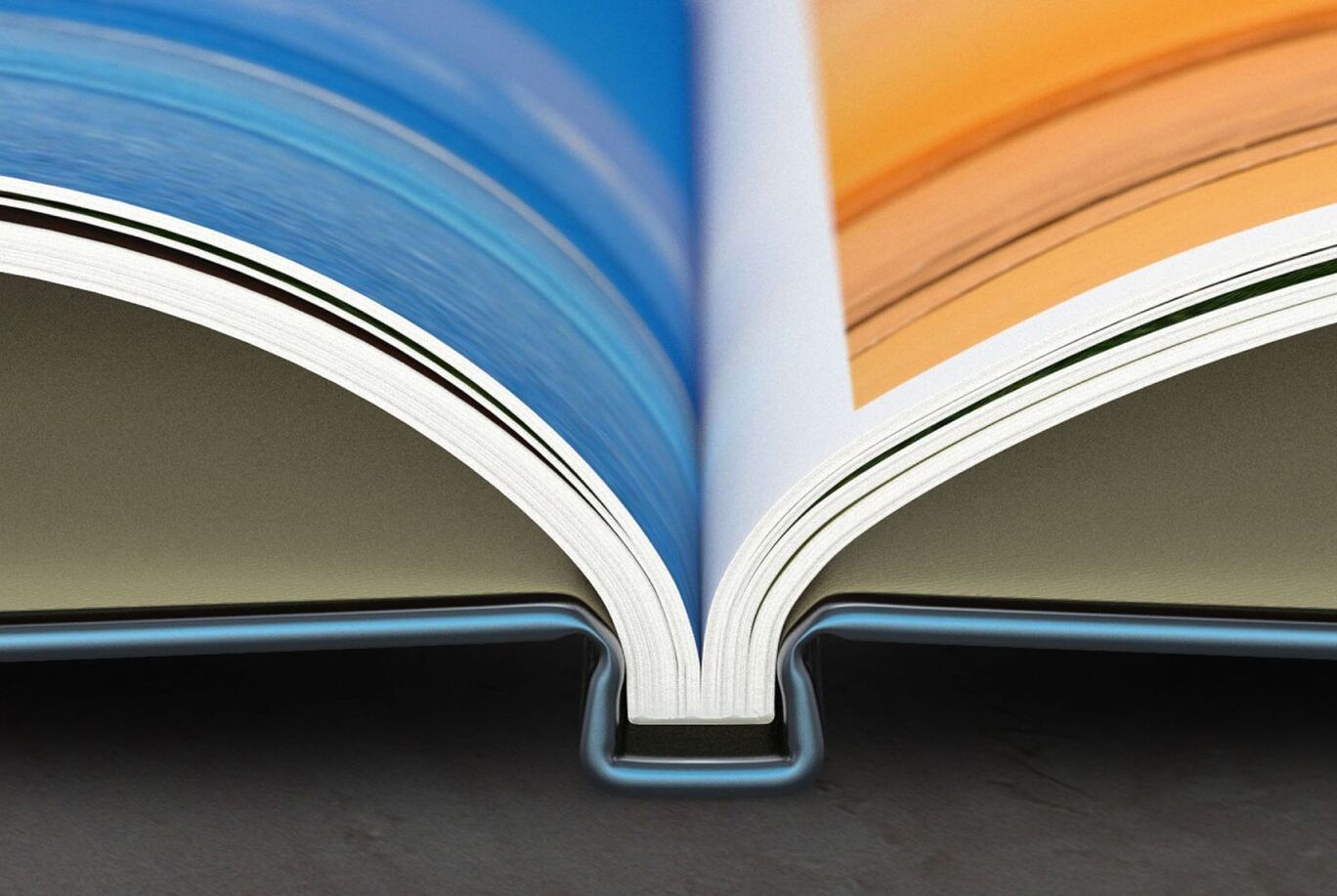 Opened photo book shows colorful pages in blue and orange.