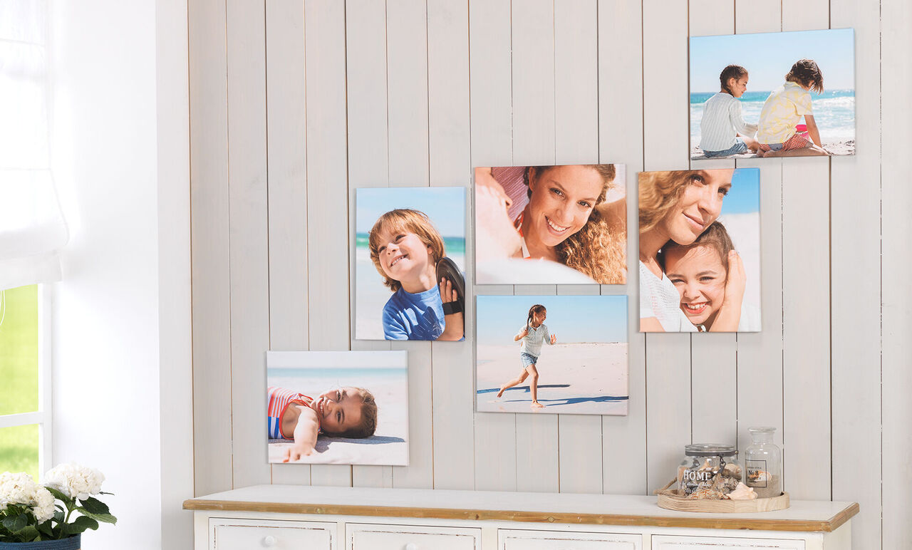 Colorful wall images of family moments at the beach, with happy children and adults.