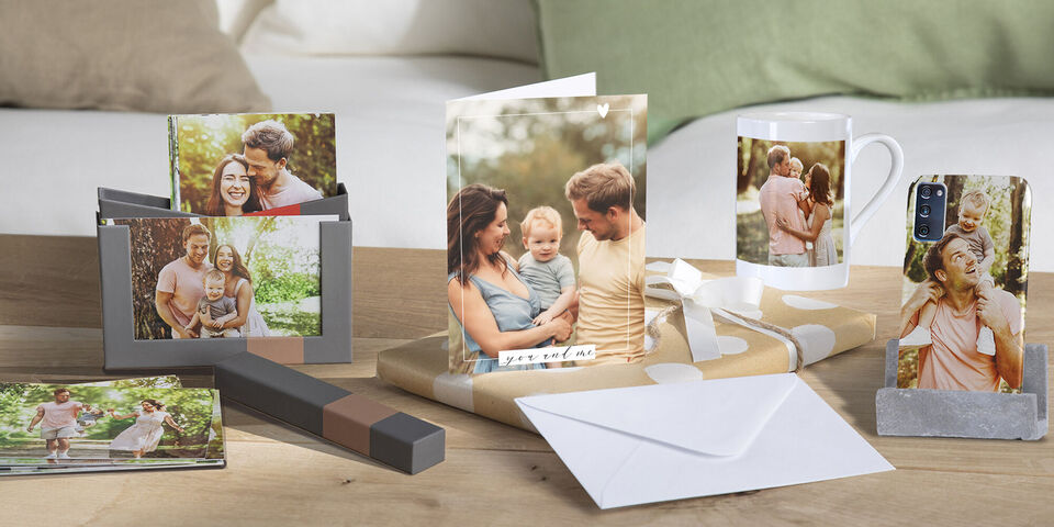 Various personalized gift ideas like photo books, greeting cards, and gifts on a table showing memories.