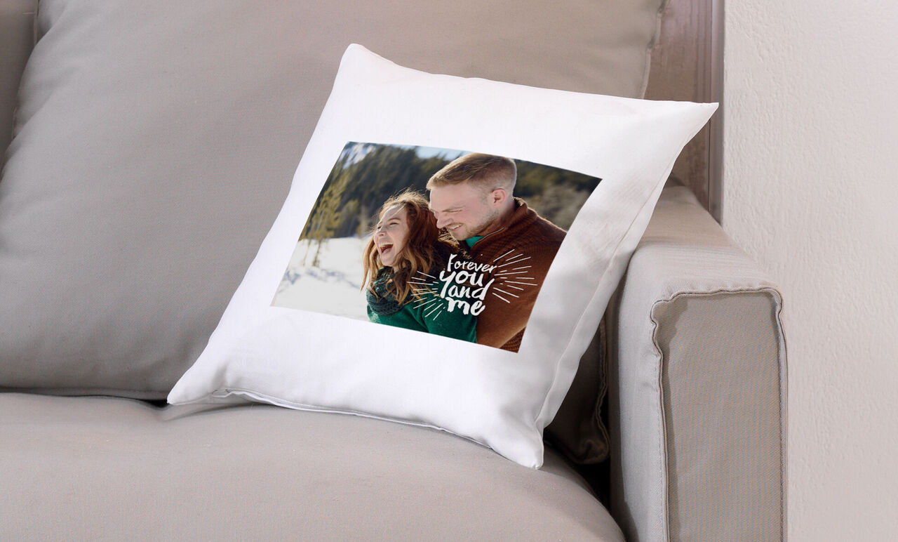 A cozy cushion with a loving photo of two people in a natural setting