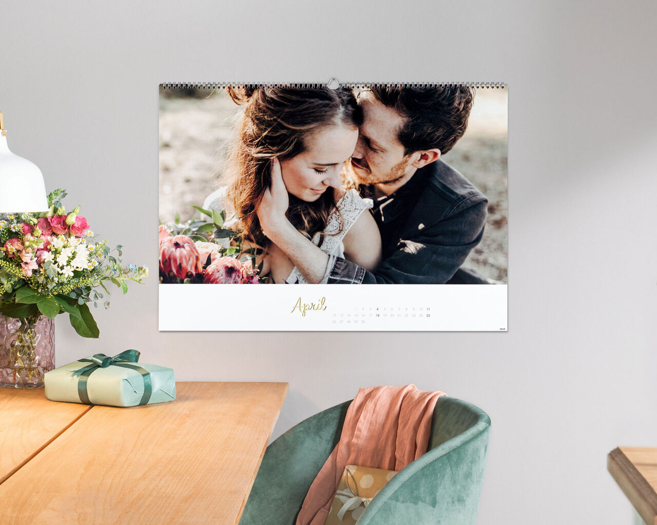 A beautiful photo calendar featuring a loving snapshot of a couple embracing, looking romantically at the camera surrounded by flowers.