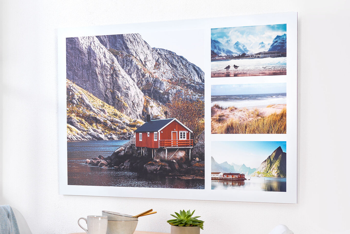 A red wooden house with white window frames on a small island, surrounded by mountains. Next to it are three smaller images of landscapes and beaches.