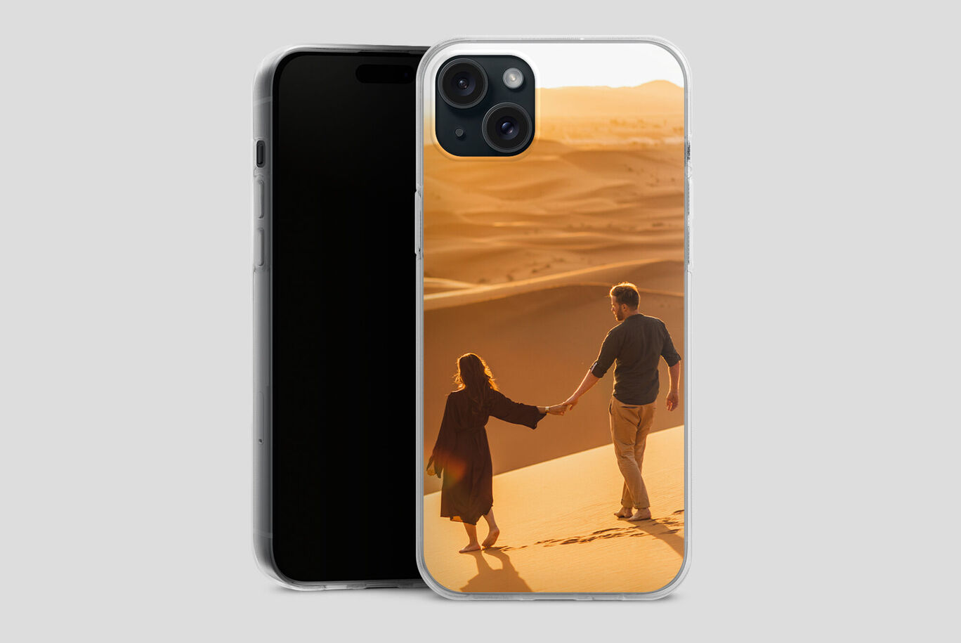A couple holding hands walks on a sandy beach at sunset, they are happy and enjoying the moment.
