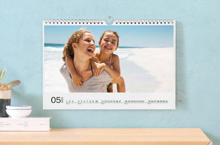 A beautiful photo calendar displays a snapshot of a happy mother and daughter on the beach.