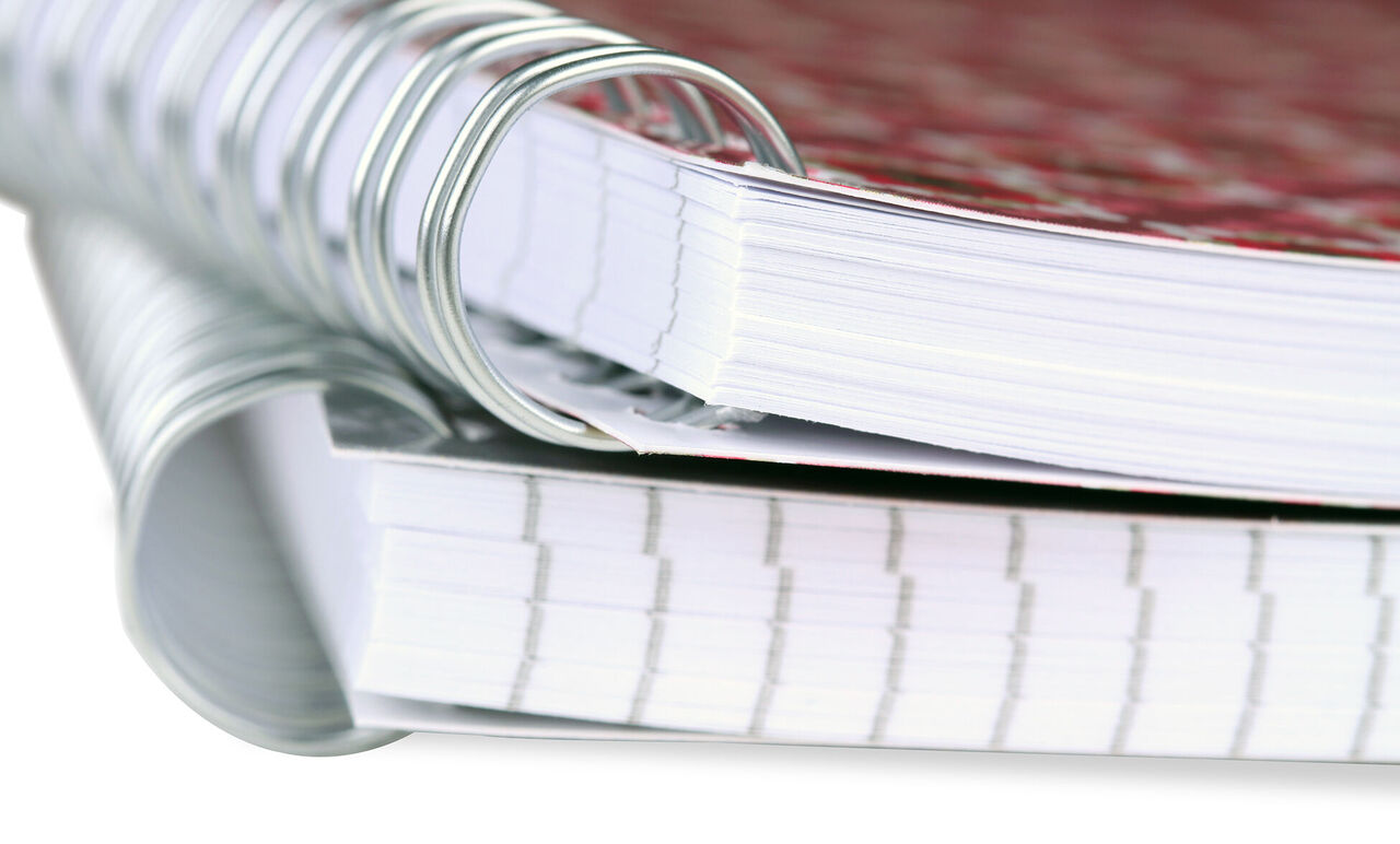 Close-up of colorful notepads with wire binding