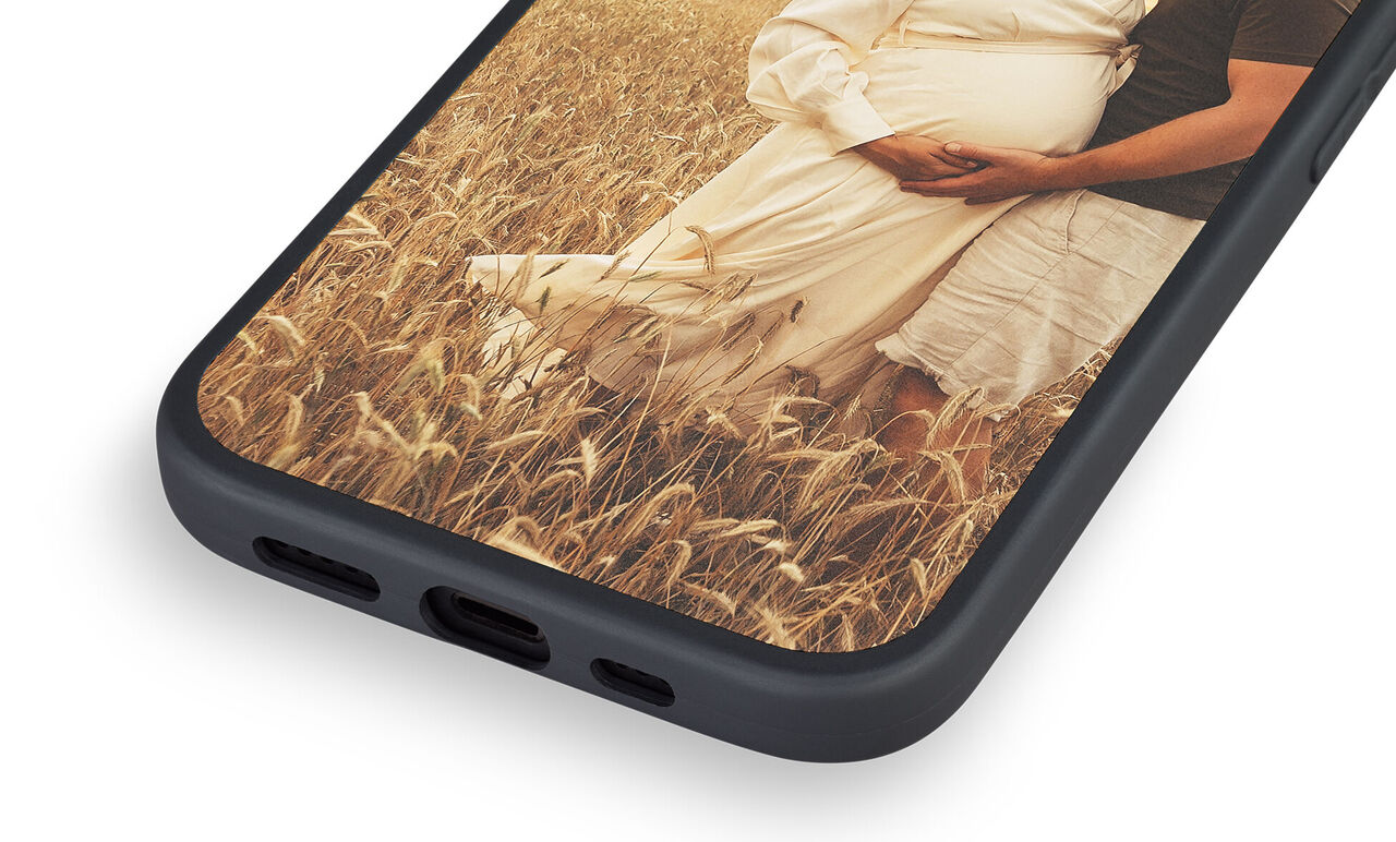 Hand with phone in the grass, inspiring moment with bridal couple.