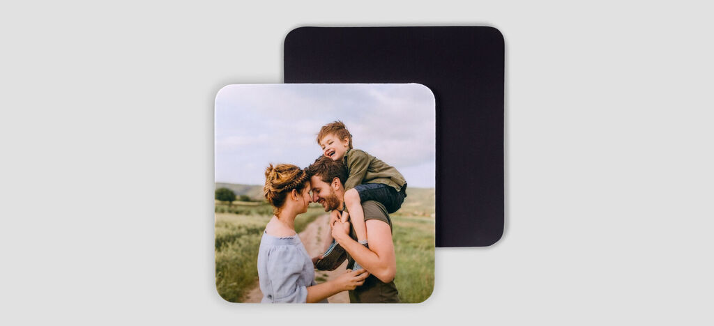 A loving family photo showing a woman with a child on her shoulders, surrounded by a green meadow.
