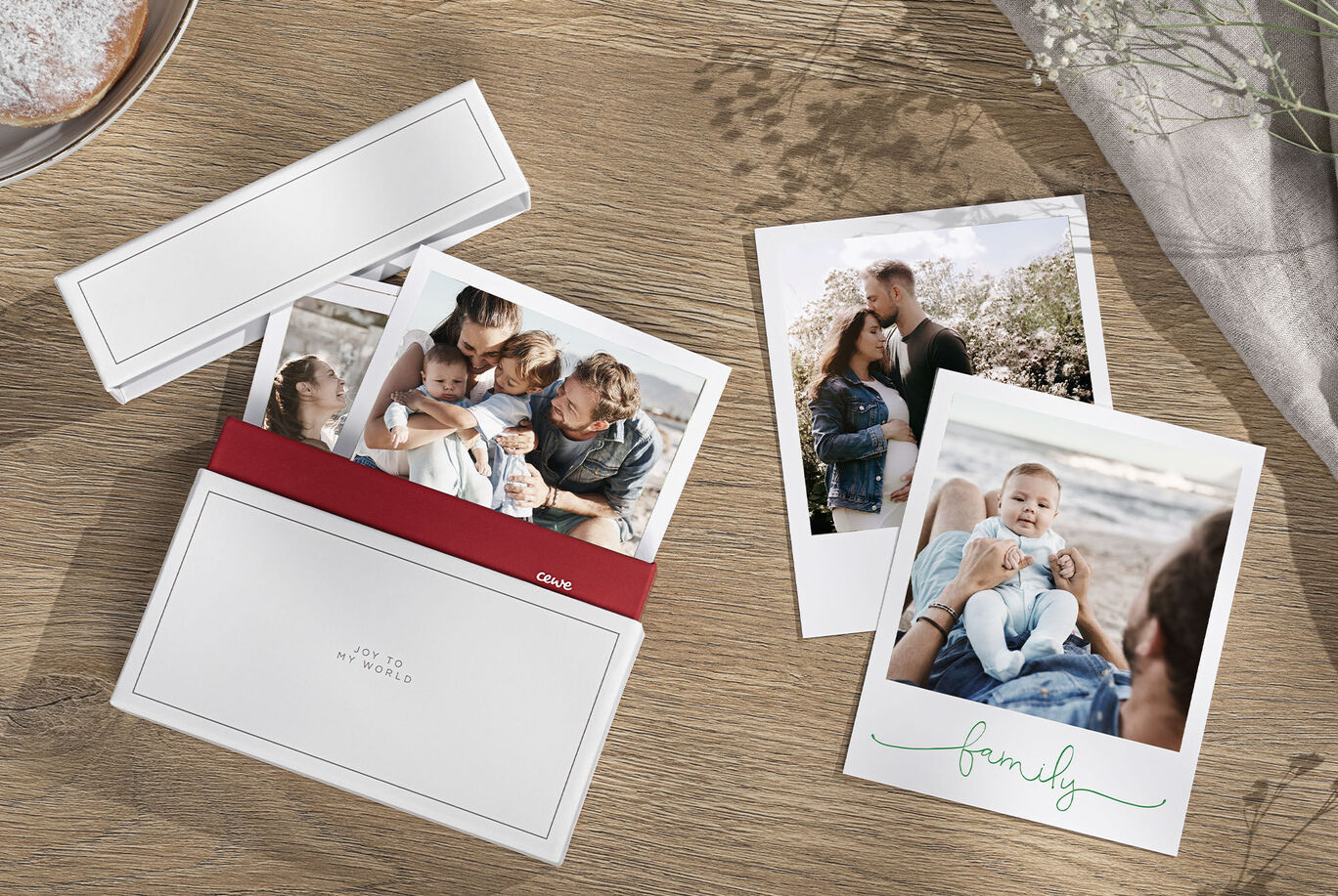 A handmade CEWE greeting card box filled with family photos and a loving message, lying on a table