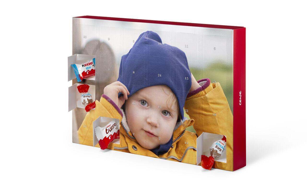 An Advent calendar with opened doors filled with small chocolate pieces.