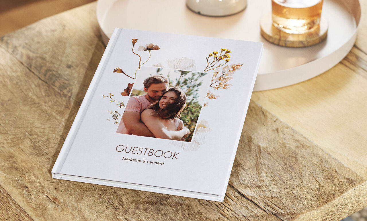 A lovingly designed guestbook on a wooden table.